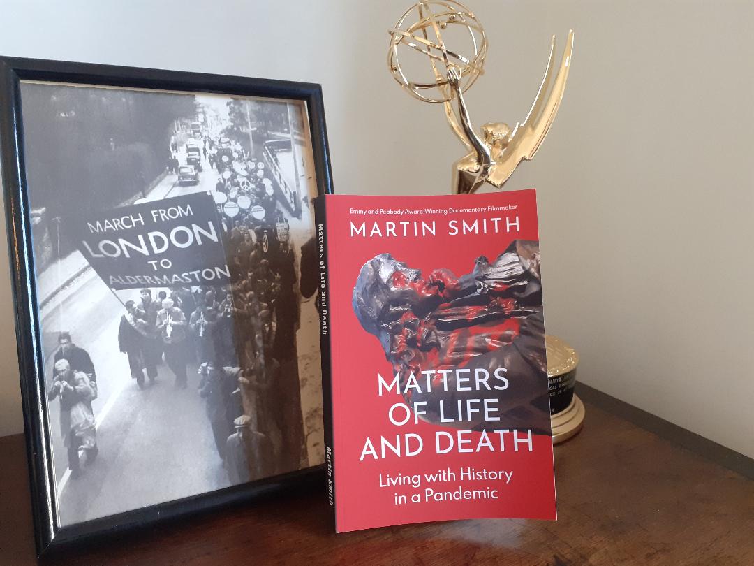 Photo of 'Matters of Life and Death' (book), Martin's Emmy award and a framed photo of a march on Aldermaston